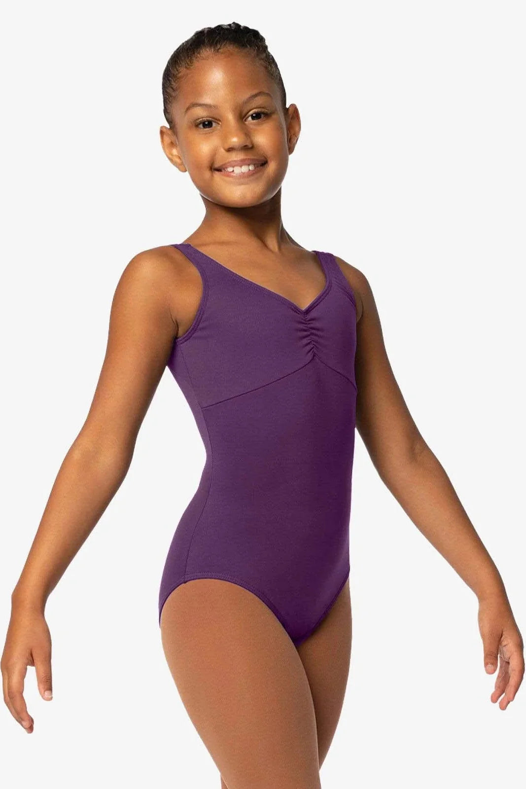 Young girl wearing a purple leotard on a white background