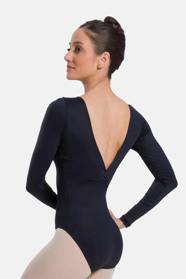Woman wearing a black long-sleeve leotard on a white background